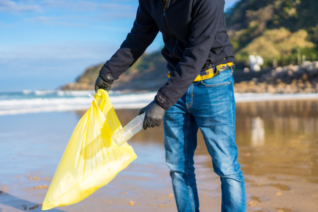 Sea pollution, unrecognizable person throwing a plastic water bottle. ecology conceptの写真素材