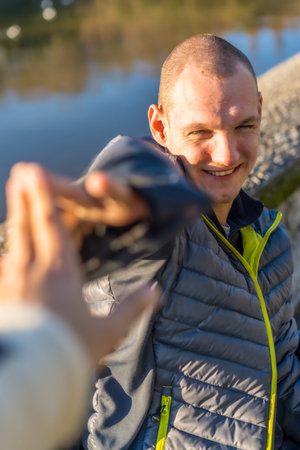 Portrait of a disabled person in a wheelchair giving a high five to a friend