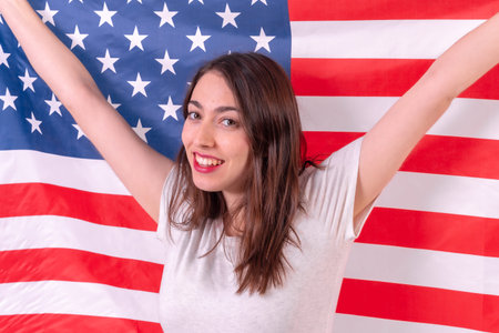 caucasian woman smiling with usa flag isolated on a white background, closeup