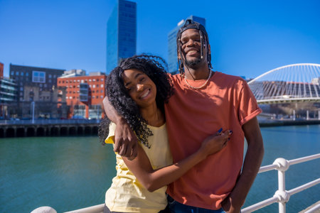 Young African American couple in the city, lifestyle friends concept, portrait embracing smilingの写真素材