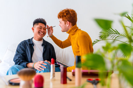 Beautiful gay couple doing makeup and having fun being romantic at home, lgbt conceptの写真素材