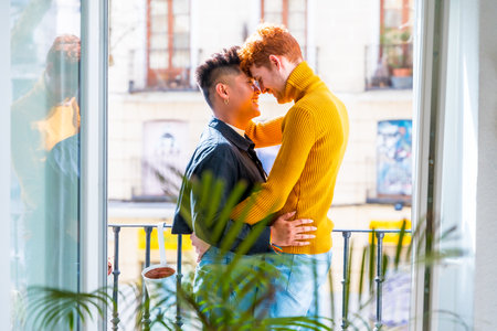 Beautiful gay couple being romantic by the window holding each other, lgbt conceptの写真素材