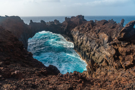 El Hierro Island. Canary Islands, the Arco de la Tosca incredible natural monument of an arch by the seaの写真素材