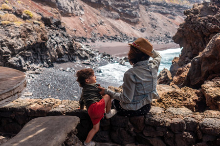 Mother and son in the recreational area for barbecues on the Verodal beach on El Hierro Island. Canary Islandsの写真素材