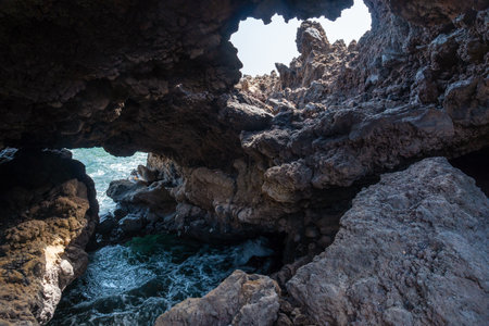 Beautiful coastline with stone caves at Muelle de Orchilla on the southwest coast of El Hierro. Canary Islandsの写真素材