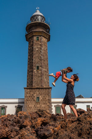 Mother and son playing having fun in the beautiful lighthouse of Orchilla in southwest El Hierro. Canary Islandsの写真素材