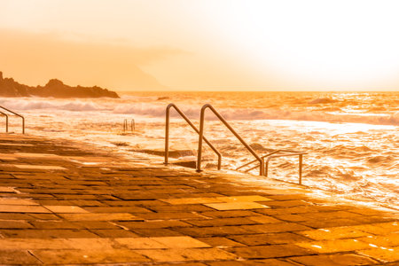 Stairs at sunset in the La Maceta rock pool on the island of El Hierro en la Frontera, Canary Islandsの写真素材