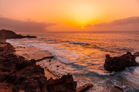 Wonderful orange sunset in the Natural Pools of La Maceta in El Hierro en la Frontera, Canary Islandsの写真素材