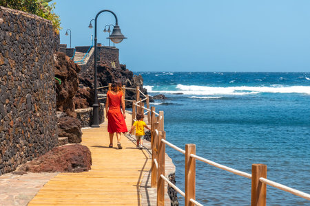 A mother and son on holiday in the seaside tourist village of Tamaduste on the island of El Hierro, Canary Islands, Spainの写真素材