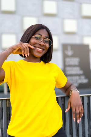 City Chic: A Confident Black Woman with Glasses Radiates Style and Graceの写真素材