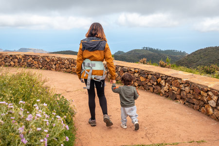 Mother and son walking and looking at the views from the top of Garajonay in La Gomera, Canary Islandsの写真素材
