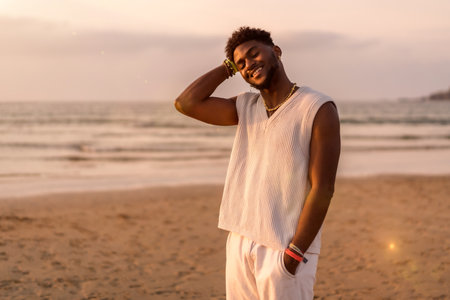 Portrait of black ethnicity model enjoying summer vacation by the sea smiling and enjoying by the seaの写真素材