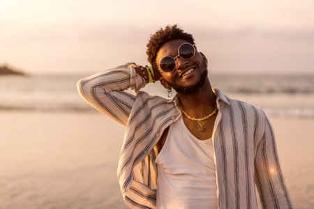 Portrait of black ethnic model enjoying summer vacation by the sea smilingの写真素材