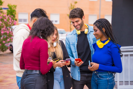 Group of multiethnic friends having fun browsing with mobile phone, young millennials mobile phone technology conceptの写真素材