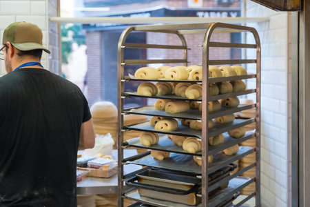 Baker of bakery in the workshop of artisan bakery preparing the Neapolitan buns for breakfasts