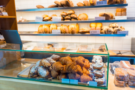 Bakery in the workshop workshop of artisan bakery and shop placing croissant and neapolitanの写真素材
