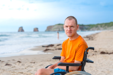Portrait of a disabled person in a wheelchair on the beach enjoying natureの写真素材