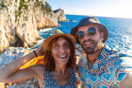 Selfie of a couple of tourists at the Ducato Lefkas Lighthouse or Cape in the southern area of the...