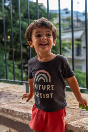 Portrait of a very cheerful two year old boy enjoying the summer vacationの写真素材