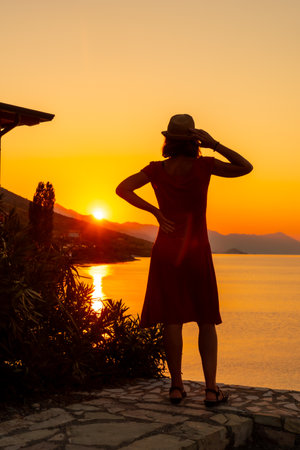 Silhouette of a woman at sunset at Shkoder lake in Shiroka municipality, summer vacation. Albaniaの写真素材
