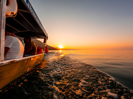 View from below along the orange sunset water of Shkoder Lake in Shiroka from a tourist boat. Albaniaの写真素材