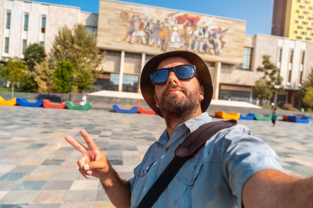 Selfie of a tourist blogger at the entrance to the National Historical Museum in Skanderbeg Square in Tirana. Albaniaの写真素材