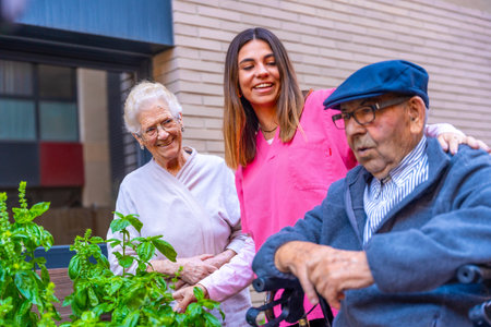 Nurse and seniors in a vegetable garden in a nursing homeの写真素材