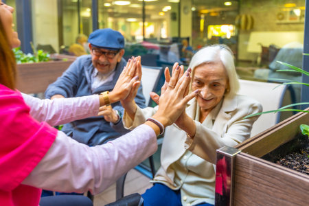 Cropped image of a playful cute nurse with elder people in a nursing homeの写真素材