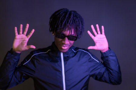 Dark studio portrait of a free style african musician posingの写真素材