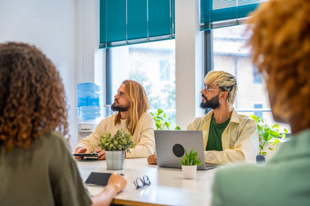 Coworkers paying attention to a speech of a colleague in a meetingの写真素材