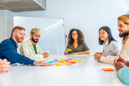 Creative process using adhesive notes in a coworking with young and multi-ethnic people