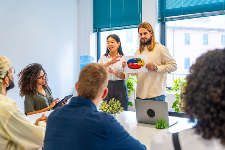 Entrepreneurs using a graph during a presentation of a project in a hubの写真素材
