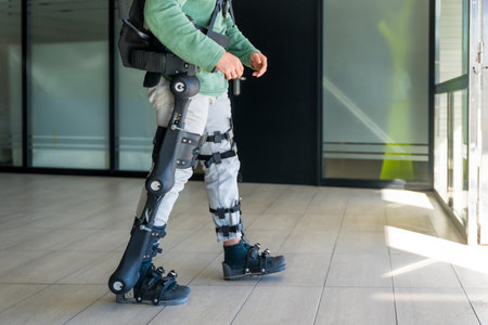 Mechanical exoskeleton, disabled person walking with the help of robotic skeleton, physiotherapy in a modern hospital, futuristic physiotherapyの写真素材
