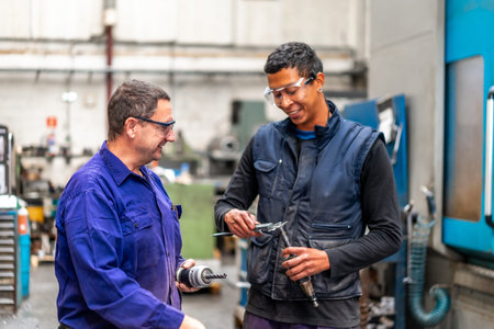 Instructor teaching and speaking the trade to a metal industrial factory worker in the numerical...