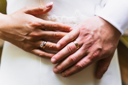 Detail of hands of bride and groom with rings at a wedding, marriage ceremonyの写真素材