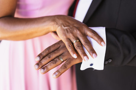 Black ethnic wedding couple showing rings at a wedding, marriage ceremonyの写真素材