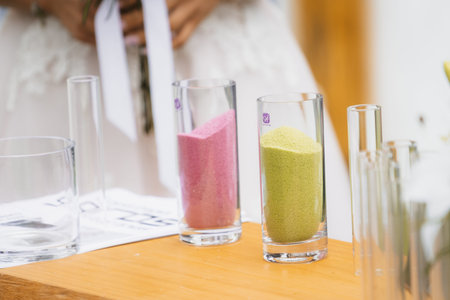 Sands of different colors and the glass vase in the marriage unity ceremony. sand ceremony