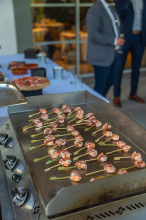 canapes frying on a hot griddle at a wedding at lunch