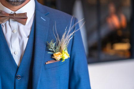 Detail of the groom's suit at the wedding with some beautiful flowers in the pocketの写真素材