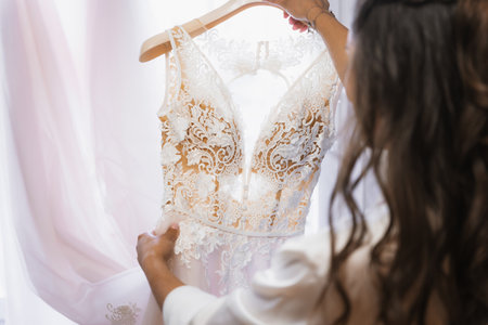 Nervous bride holding wedding dress before ceremonyの写真素材