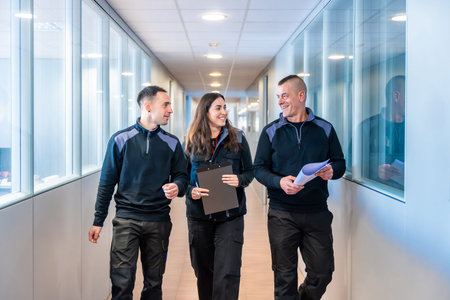 Workers of a logistics factory chatting and walking along a corridor