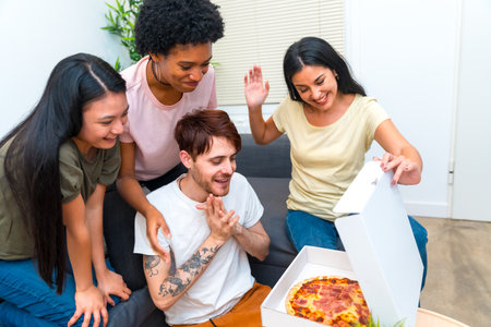 Woman enjoying a weekend with multiracial friends and pizza at homeの写真素材