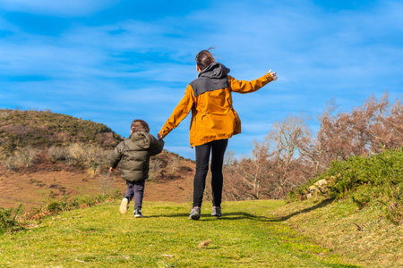 Mother with her son walking very happy through the mountains together in Erlaitz in Irun, Basque Countryの写真素材