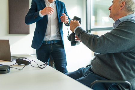 Client and businessmen in a meeting to present new augmented reality googles in the office