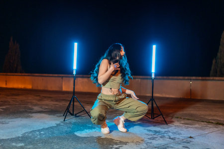 Sensual young dancer dancing trap modern music int the street at night