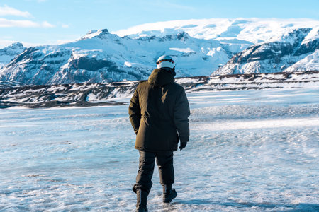 Adventurous young man walking on Vatnajokull glacier in winter in Iceland