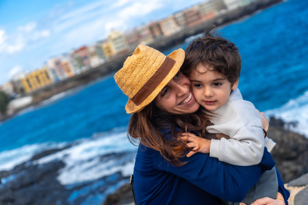 Mother with her son hugging on summer vacation at sea, enjoying familyの写真素材