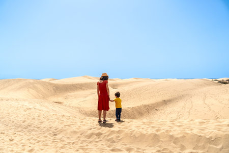 Mother and son on vacation very happy in the dunes of Maspalomas, Gran Canaria, Canary Islandsの写真素材