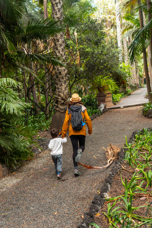 A mother and child enjoying and walking in a botanical garden. Family vacation conceptの写真素材