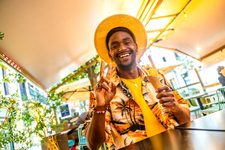 Brunette young tourist gesturing success eating an ice cream sitting on a terrace in the cityの写真素材